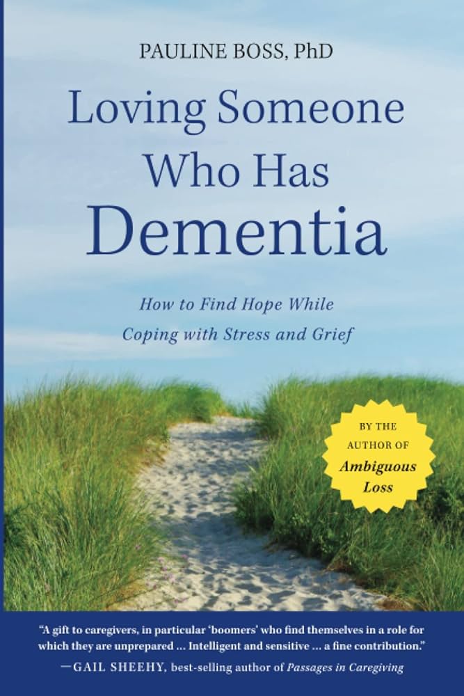 Cover of "Loving Someone Who Has Dementia," featuring a sand path through tall grass and a blue, partly cloudy sky