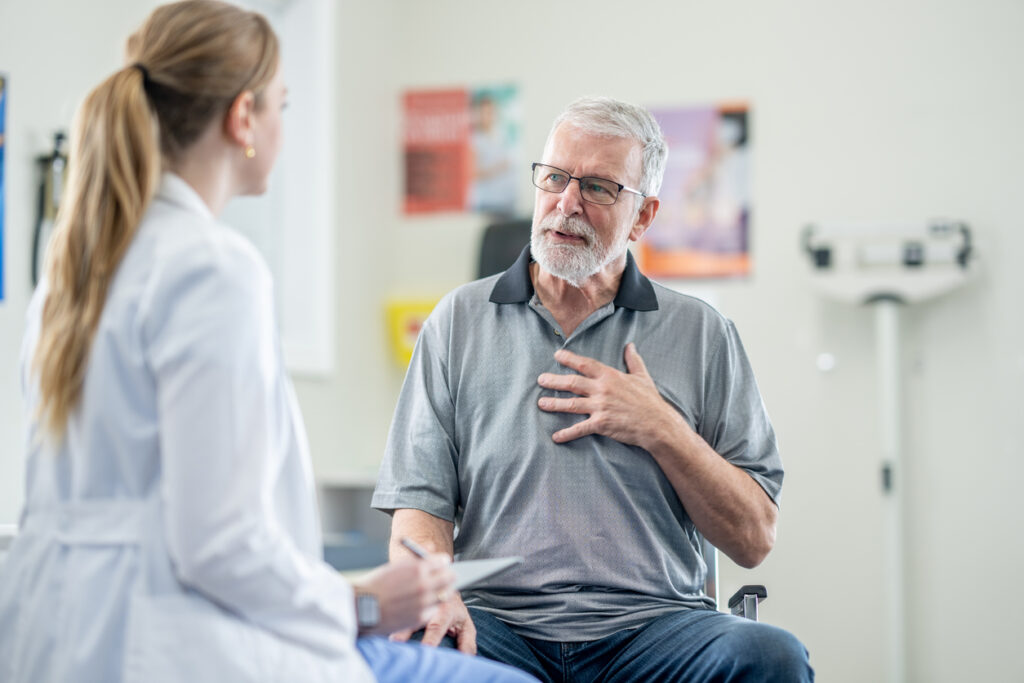 A senior man speaks with a doctor