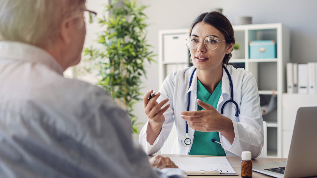 A senior sits with a doctor discussing medical issues and making a plan