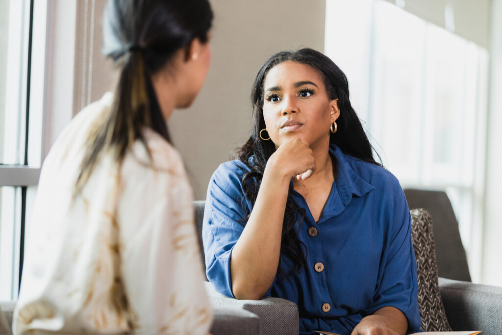 African-American woman listening intently to a care professional.